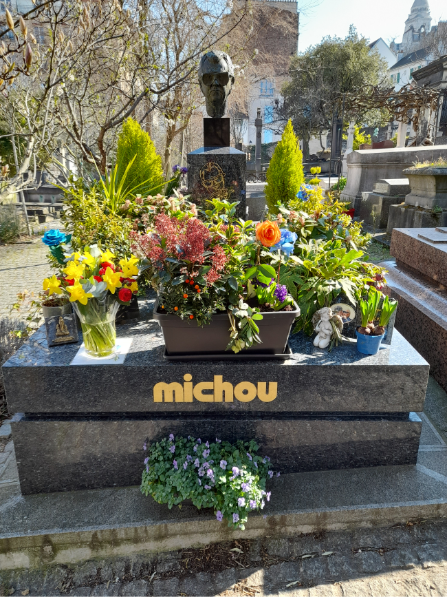 A photo of Michou's headstone at St Vincent Cemetery in Paris
