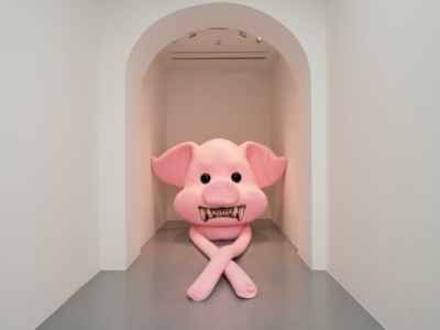 A pig soft statue crossing its arms