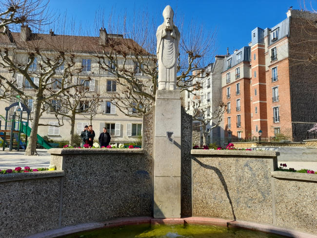 A photo of St Denis Fountain at Suzanne Buisson Square featuring a statue