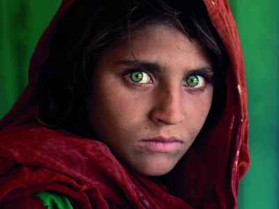 Afghan girl with green shawl by Steve McCurry