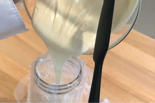 White chocolate ganache poured in a piping bag