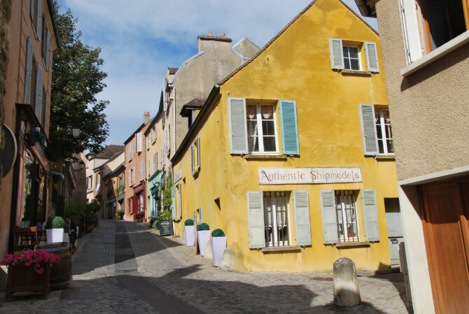Marly le Roi street with a yellow house and green window shutters