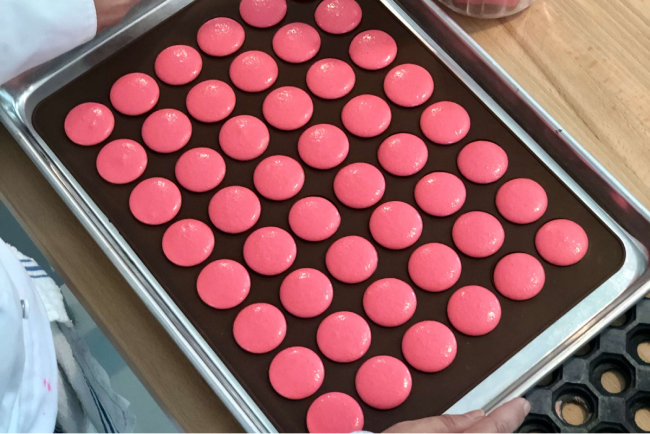 Tap the macaron shells on a table
