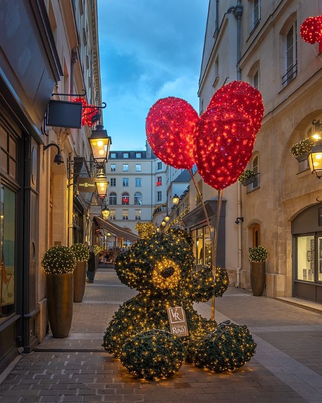 Le Village Royal Paris with a teddy bear light sculpture holding two red balloon