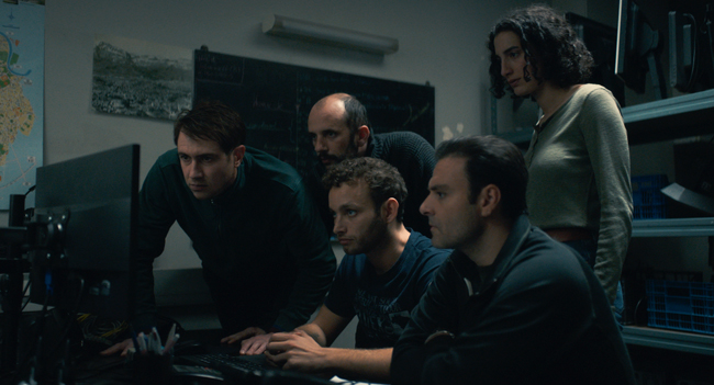 A group of five staring at a screen