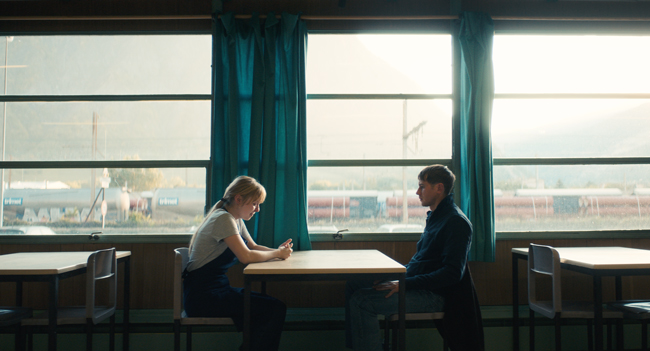 A lady and a man sitting across the table from each other