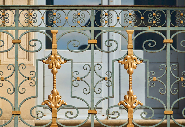 Ornamental ironwork along rear entrance of château.
