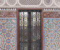 A door in the middle of ornate tiles