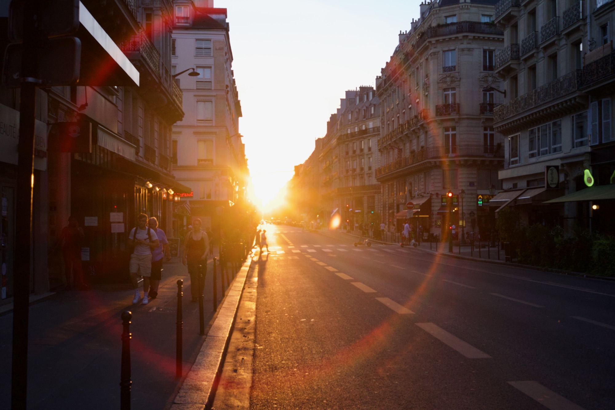 beautiful sun gleaming in the middle of a street