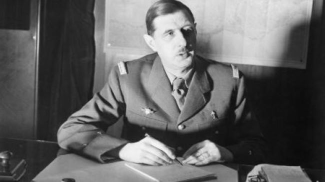 An image of General Charles de Gaulle behind a desk