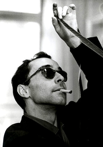 Young Jean-Luc Godard smoking a cigarette