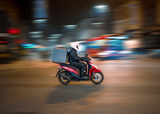 man riding motorcycle on road during nighttime