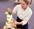 Photo of Tara Pidoux decorating a cake