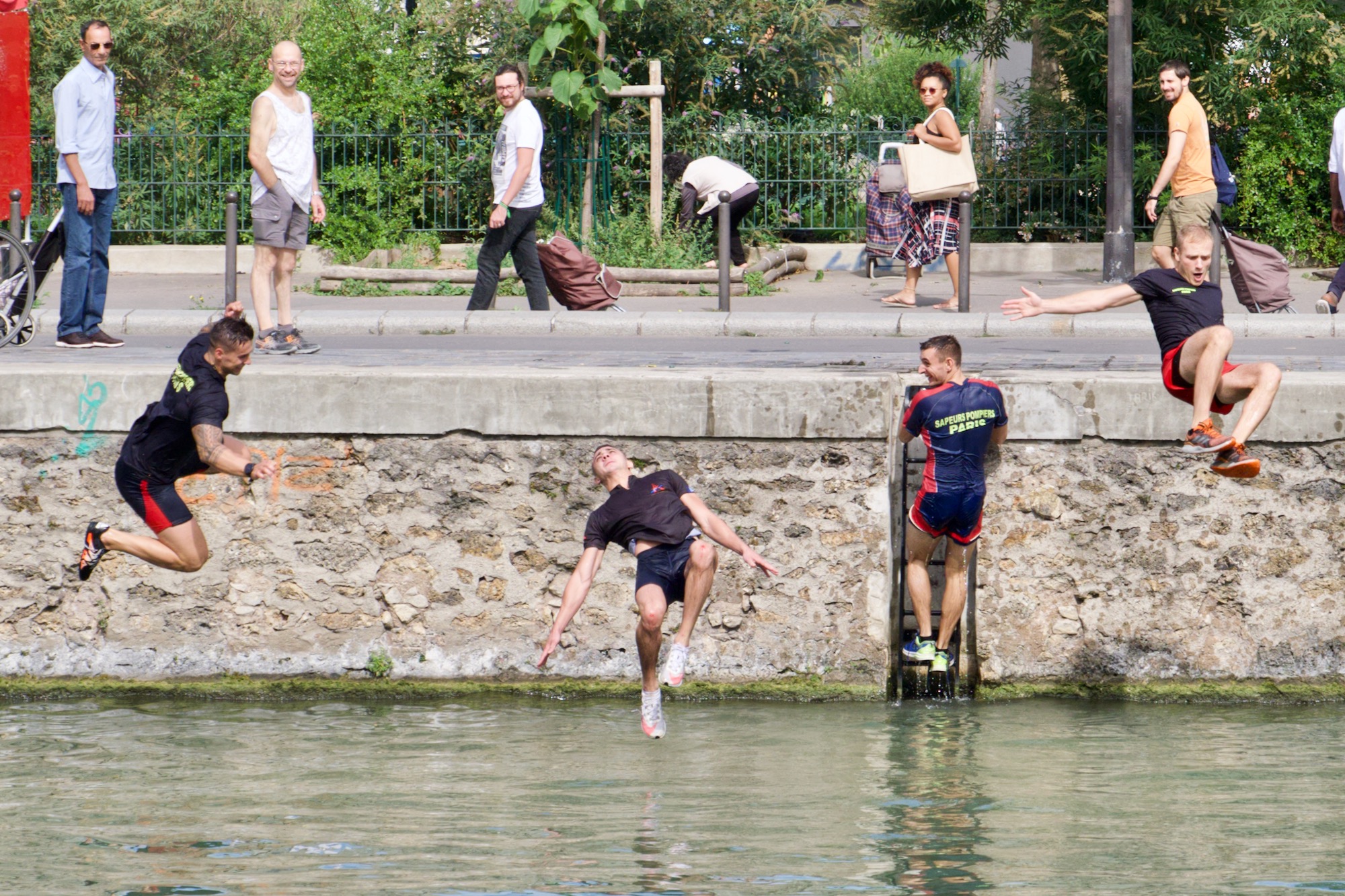 A photo of people jumping into water