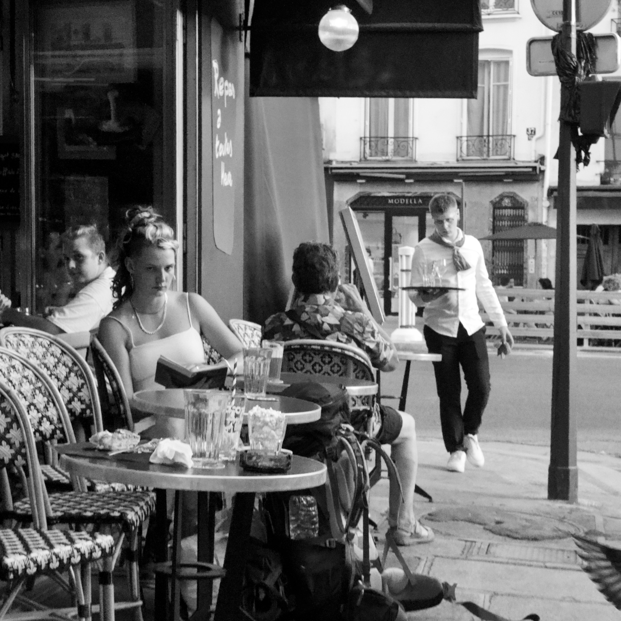 A photo of people outside a cafe