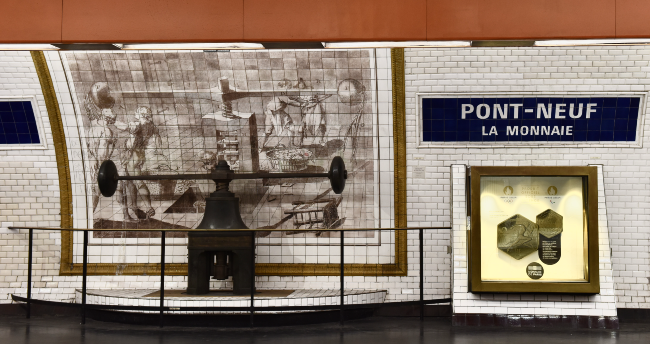 An original coin press on display in the Metro station