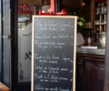 A chalkboard menu outside Cafe Max