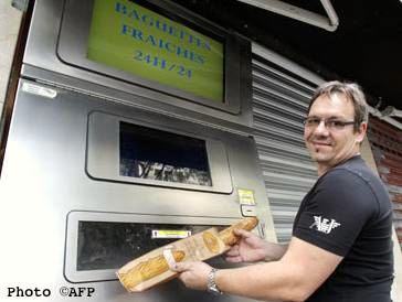 Jean-Louis Hecht & automated baguette machine. Photo credit: Metro-AFP.