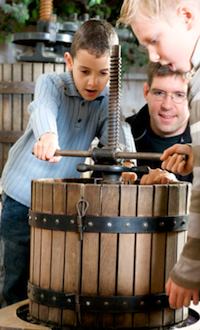 Making cider with the cider press at Ferme de Gally. Publicity photo